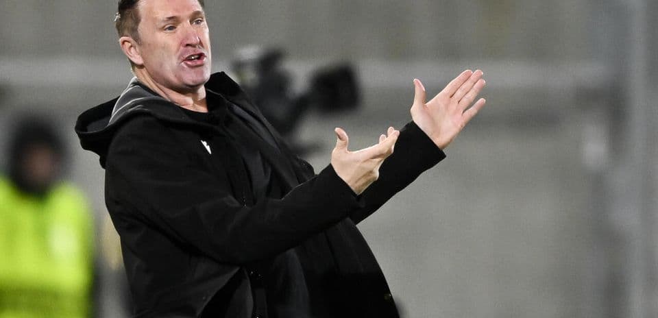 Coach gesturing during a match on the sideline