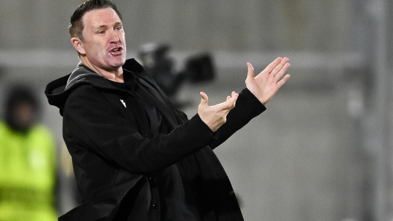 Coach gesturing during a match on the sideline
