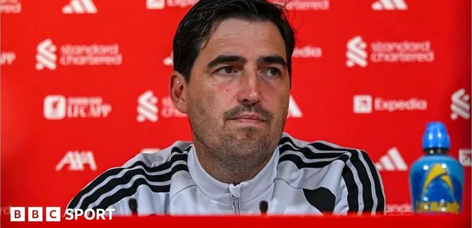 Manager at press conference with sponsor backdrop