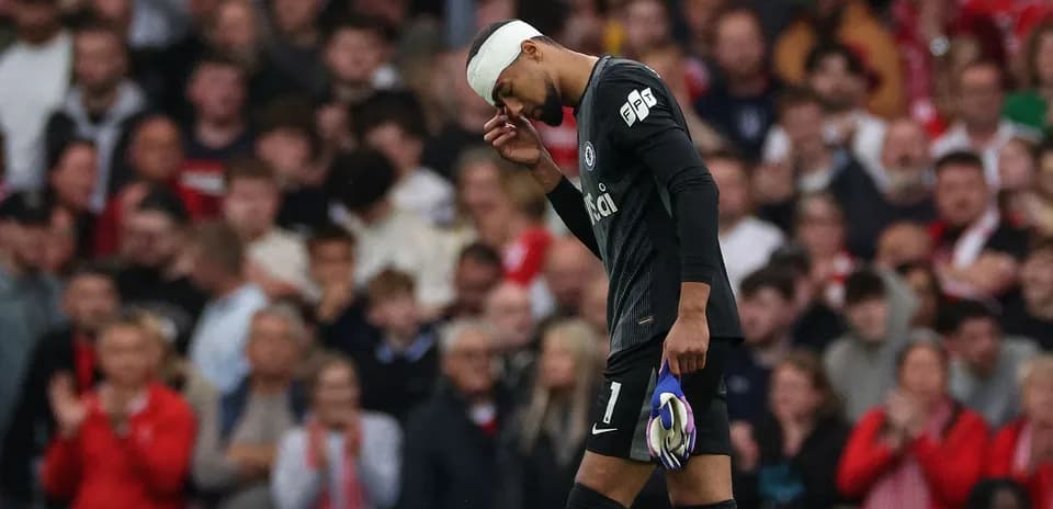 Goalkeeper walking off with bandaged head during match