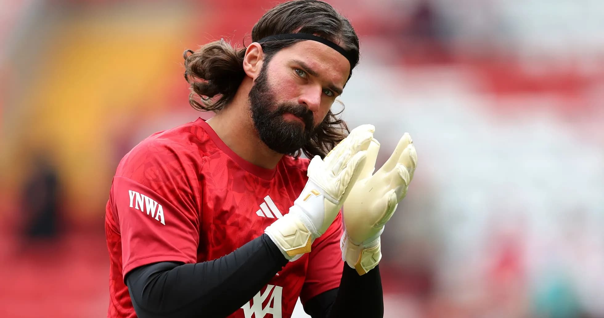 Goalkeeper warming up in red jersey and gloves