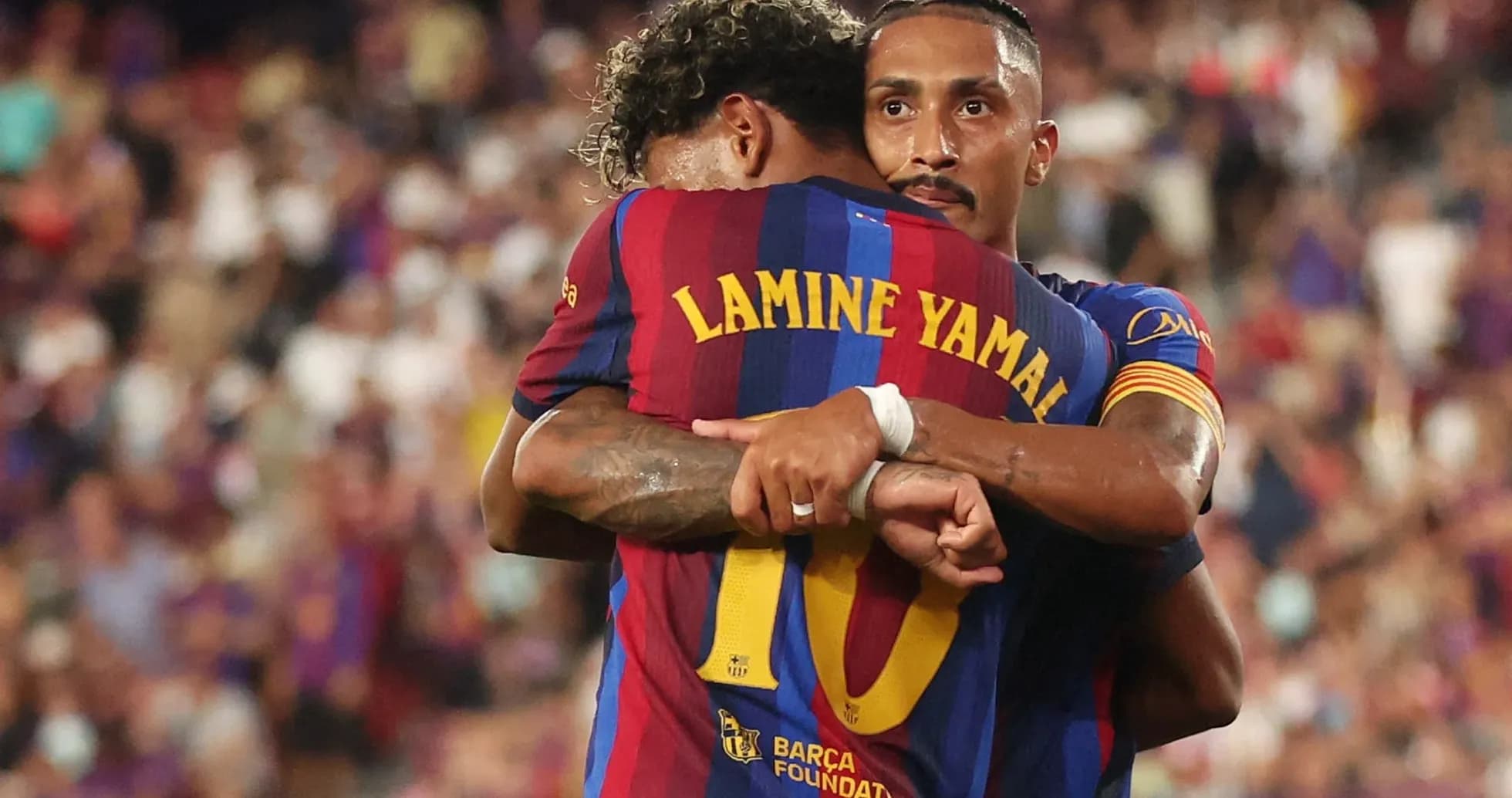 Barcelona players celebrating a goal with an embrace