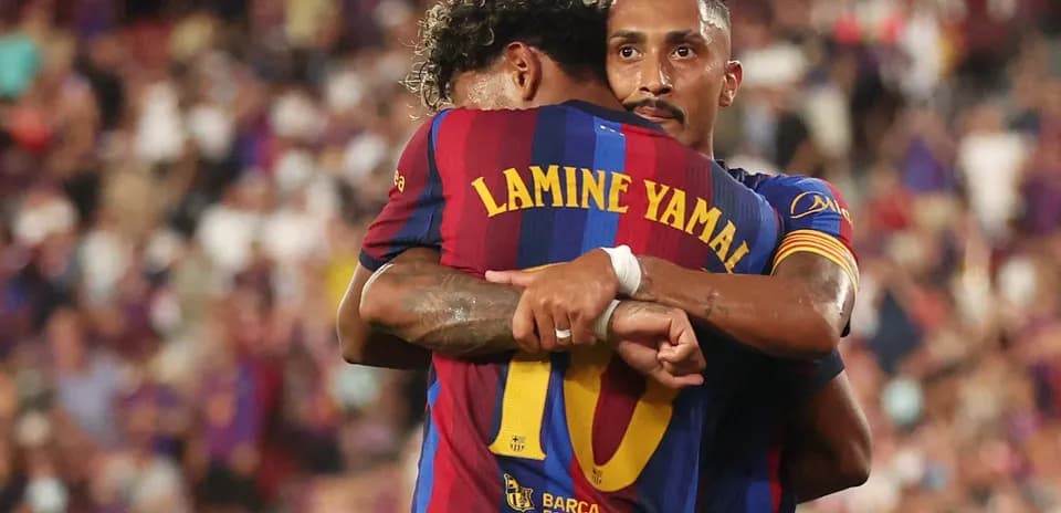 Barcelona players celebrating a goal with an embrace