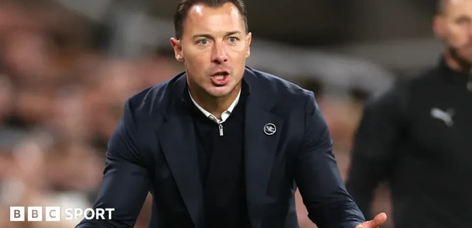 Coach gesturing during a match on the sidelines