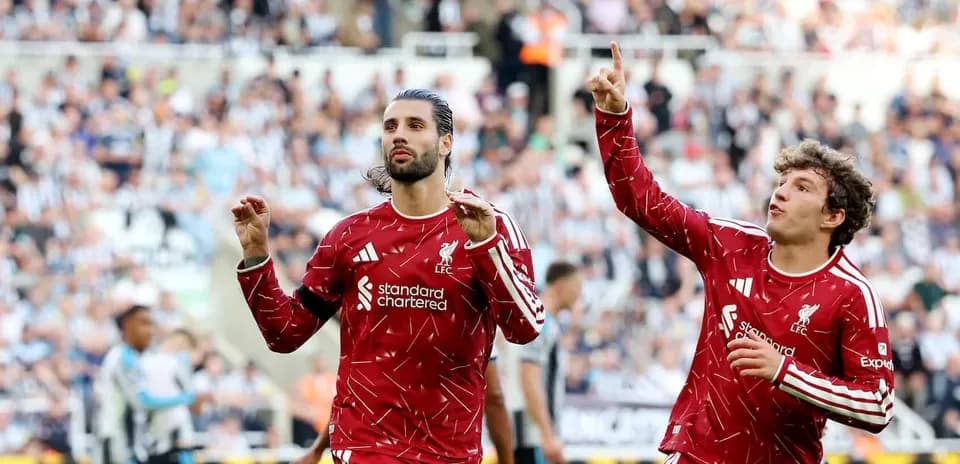 Two Liverpool players celebrating a goal during match
