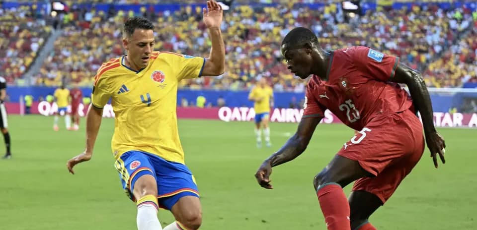 Colombian player tackles opponent during match