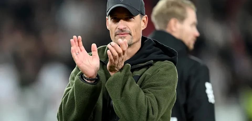 Coach applauding during match at stadium