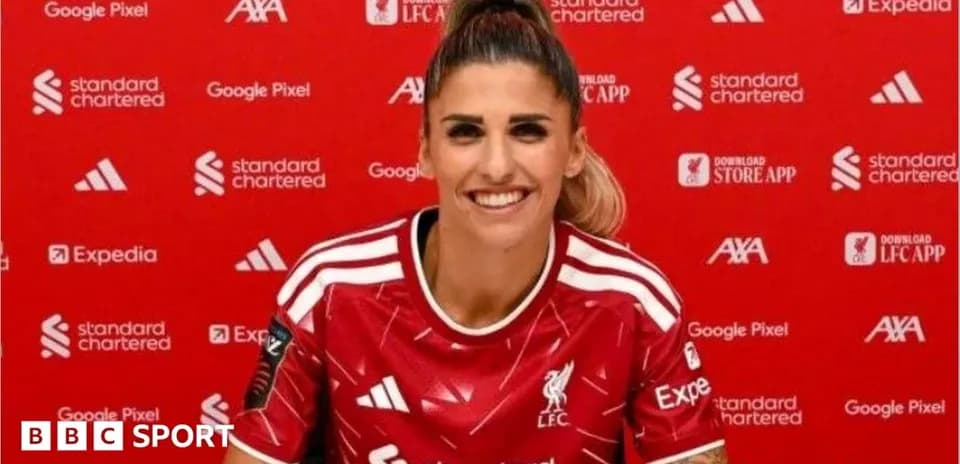Player wearing Liverpool jersey at press conference