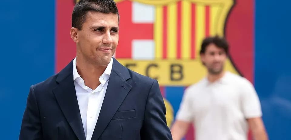 Player posing in front of FC Barcelona logo