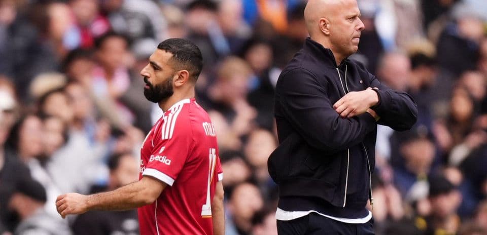 Player walking past coach during match on sidelines