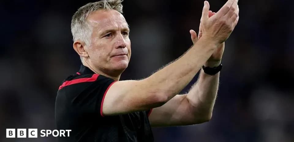 Manager applauding fans after match