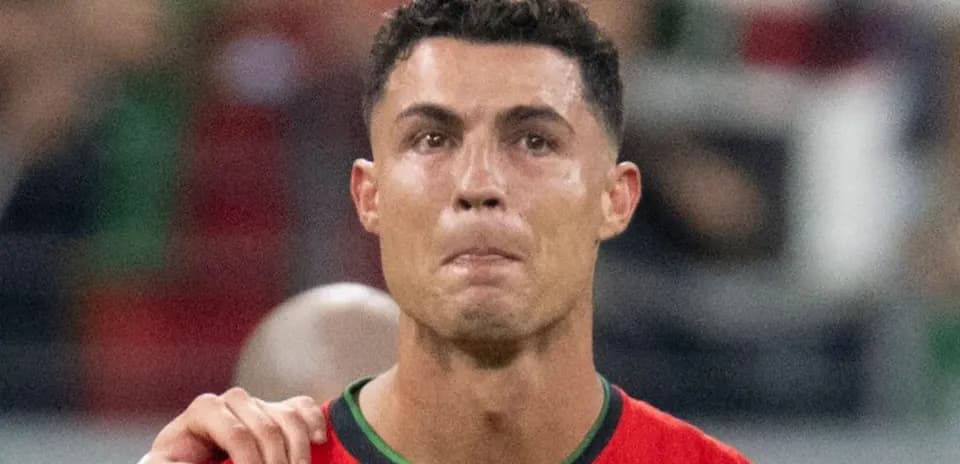 Player in red jersey during match with teammates
