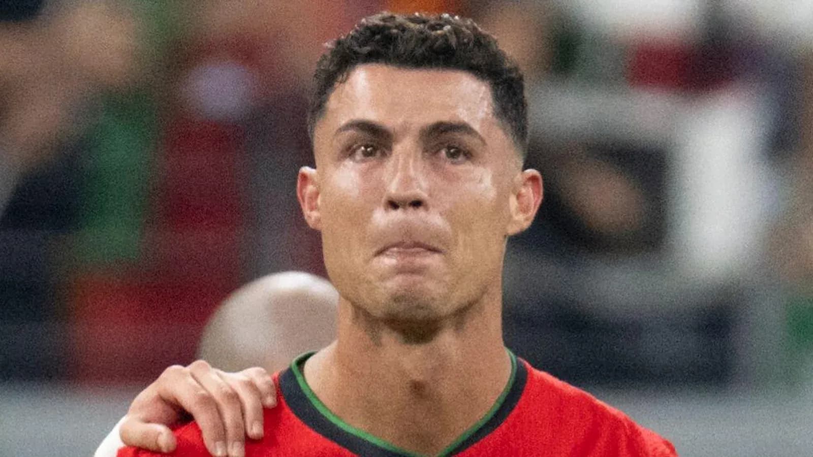Player in red jersey during match with teammates