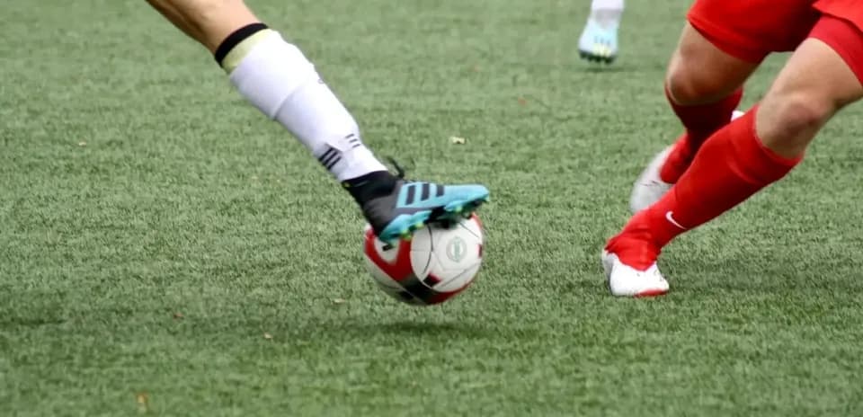 Players contesting for the ball in football match