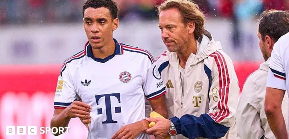 Player receiving assistance from coach on sidelines