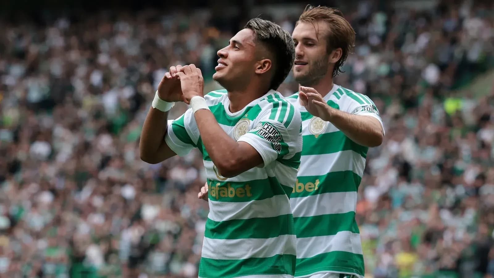Celtic players celebrating a goal in the stadium