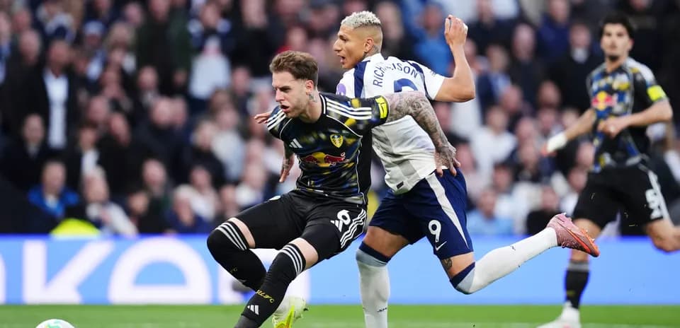 Player tackles opponent during Tottenham vs Leeds match
