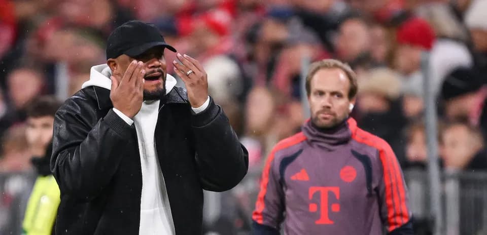 Coach gesturing during match with assistant nearby