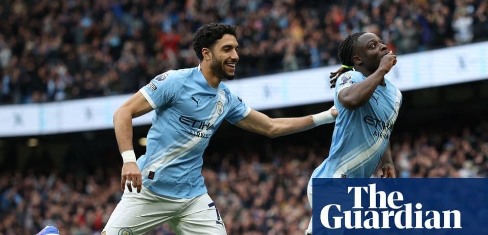 Two Manchester City players celebrating a goal