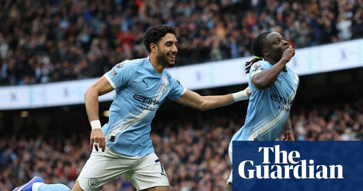 Two Manchester City players celebrating a goal