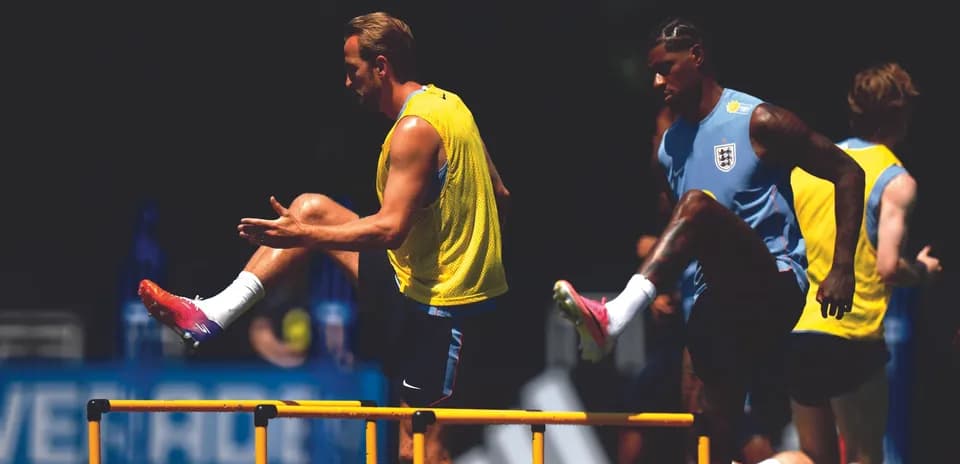 Players training over hurdles during practice session