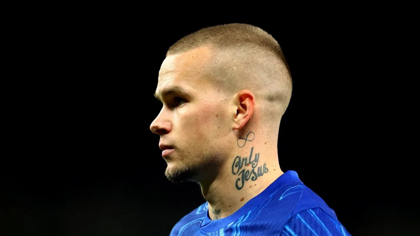 Player with tattoos wearing blue sports jersey