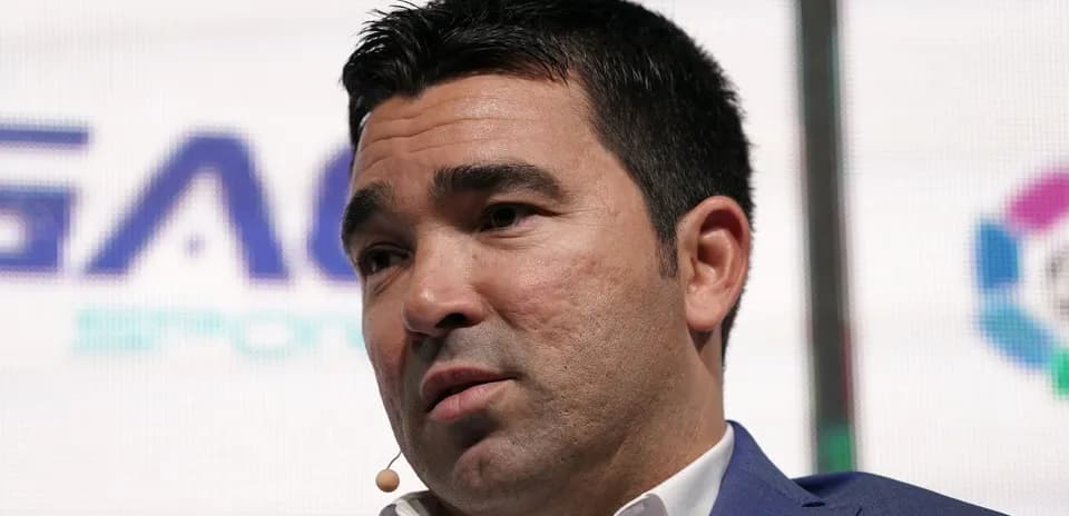 Man speaking at a conference with a microphone