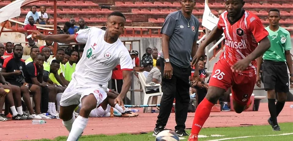 Player in white and red jerseys competing for the ball