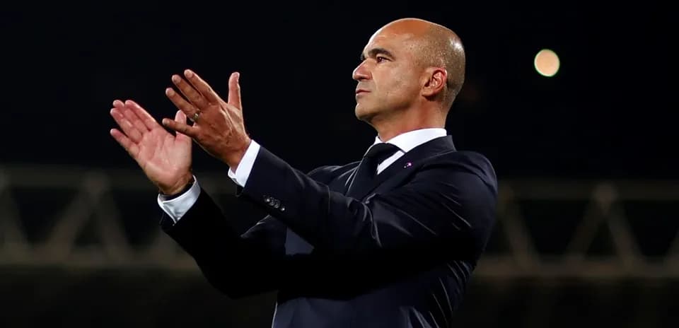 Manager applauding during a match from the sidelines