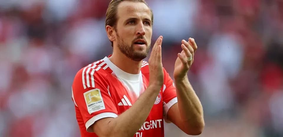 Player applauding fans in red team jersey