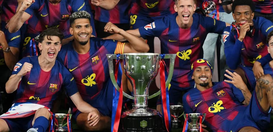 Barcelona players celebrating with trophies after victory