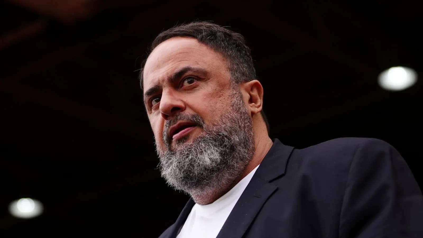 Man with beard speaking at an event