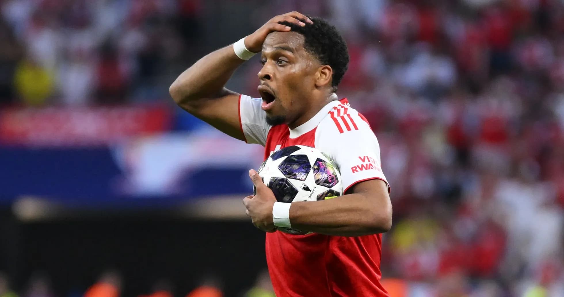 Player holding ball with surprised expression during match