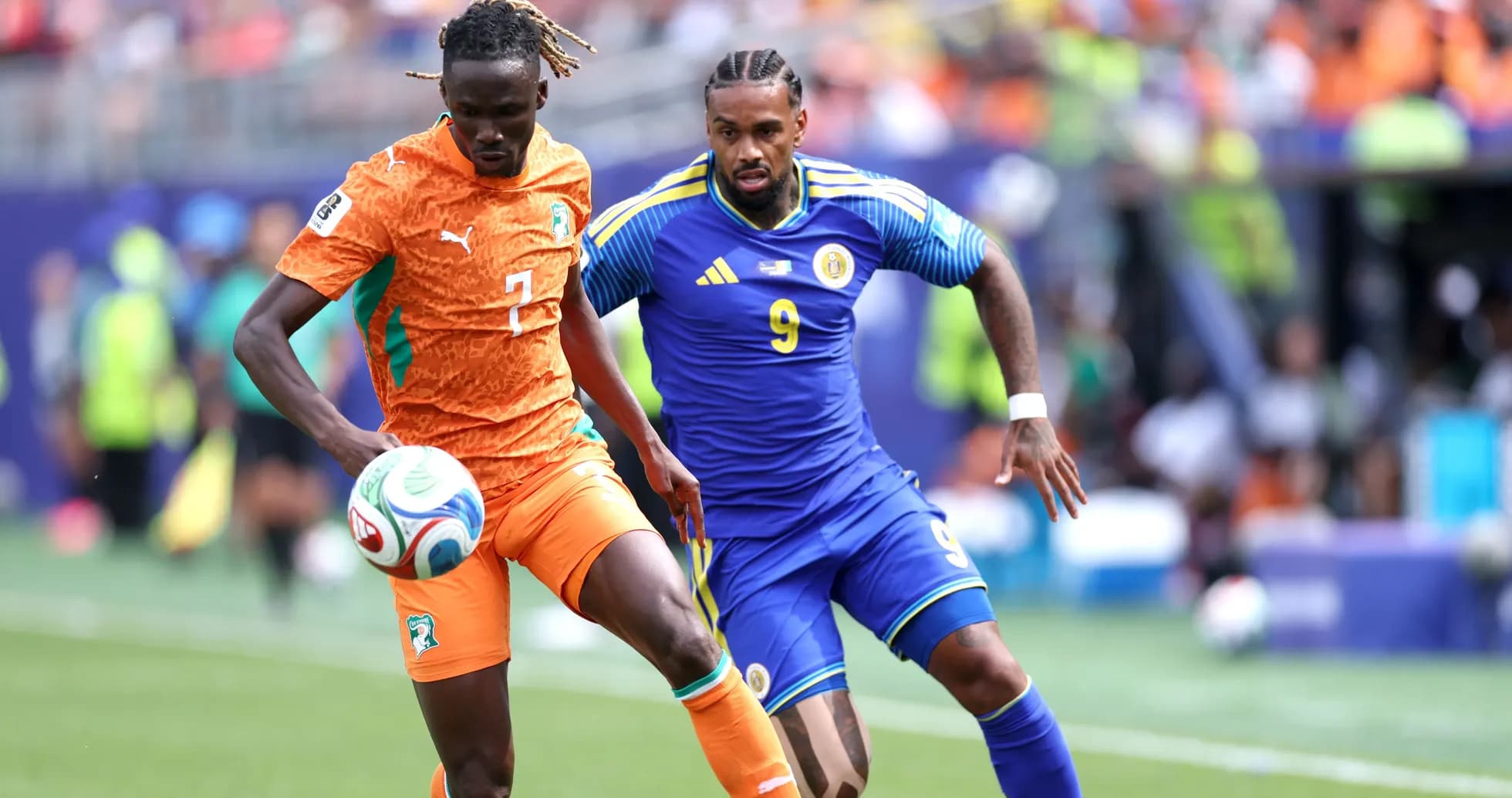 Ivorian player dribbling past opponent during match
