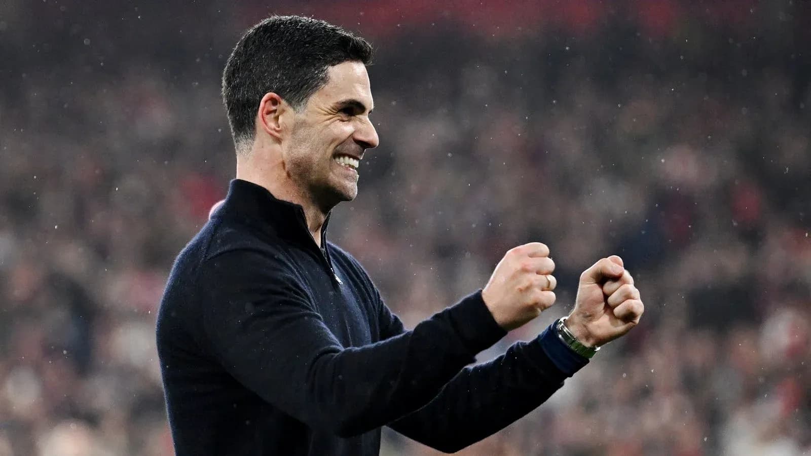 Coach celebrating with clenched fists during match