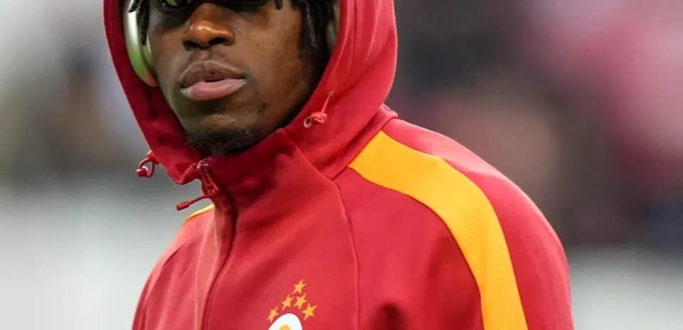 Player wearing a red Galatasaray tracksuit on field