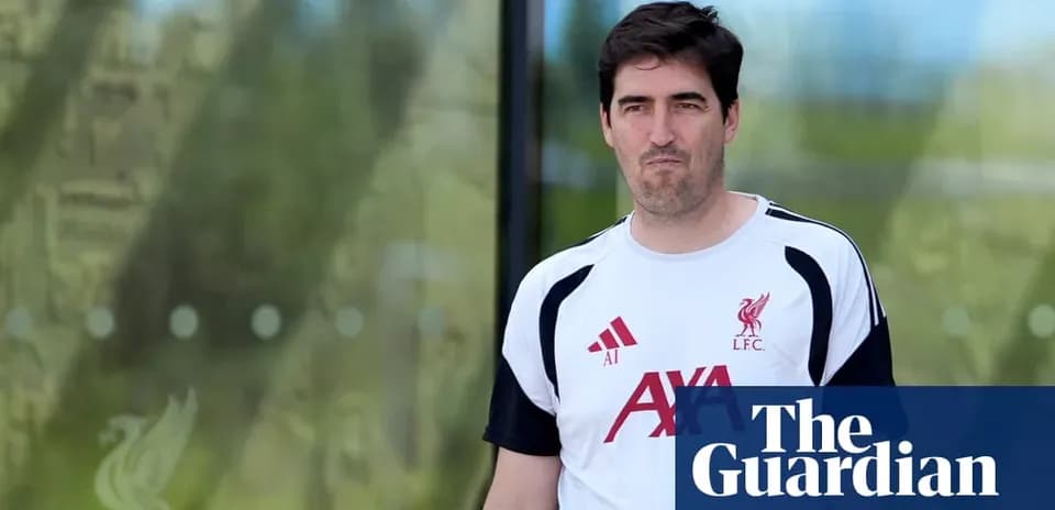 Man in Liverpool FC training shirt walking outside