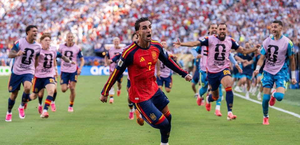 Spanish player celebrating a goal with teammates