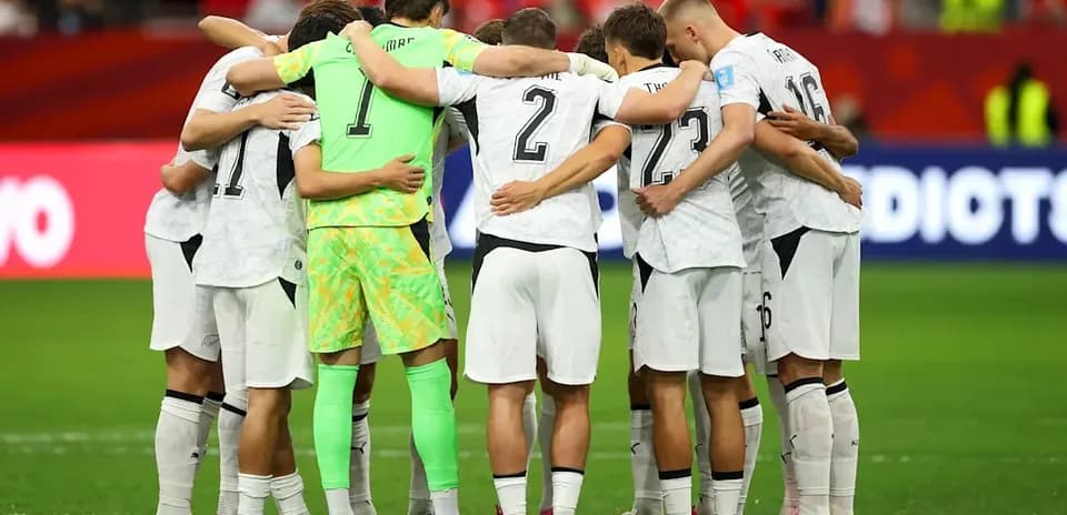 Team huddling together on the field before match