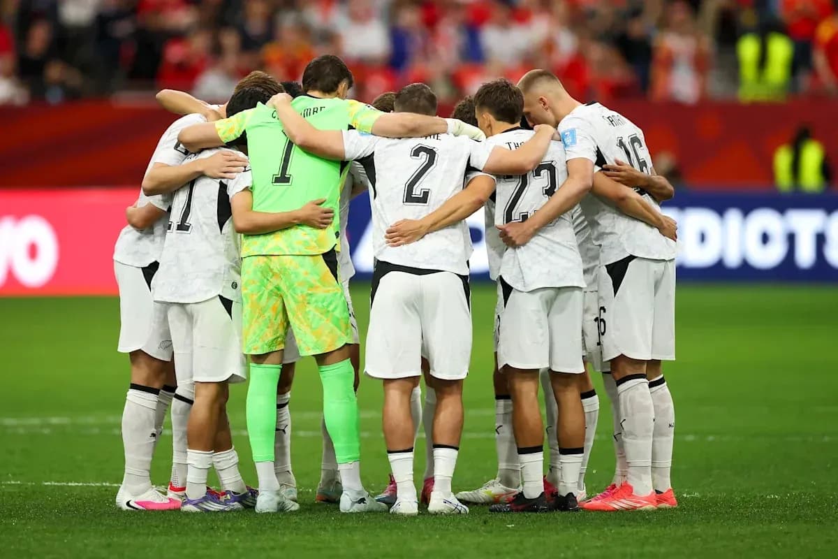Team huddling together on the field before match