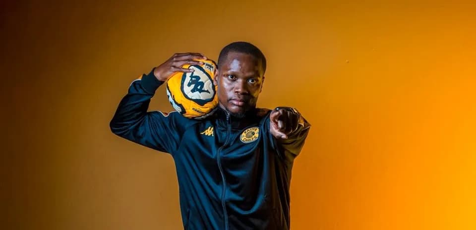 Player in Kaizer Chiefs jacket holding soccer ball