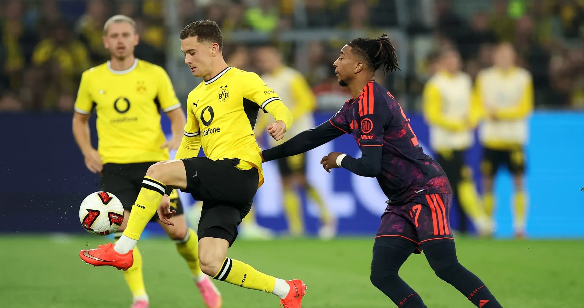Player dribbling ball while being challenged by opponent