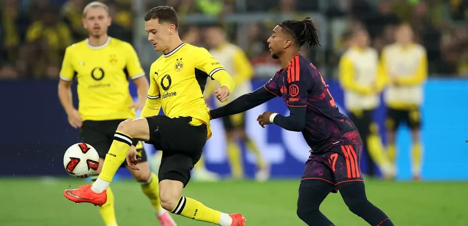 Player dribbling ball while being challenged by opponent