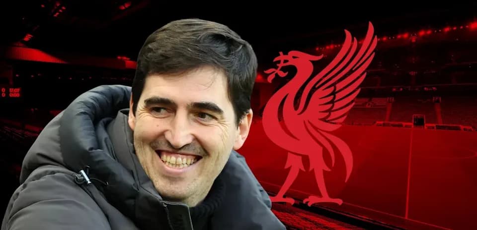 Man smiling with Liverpool logo in background