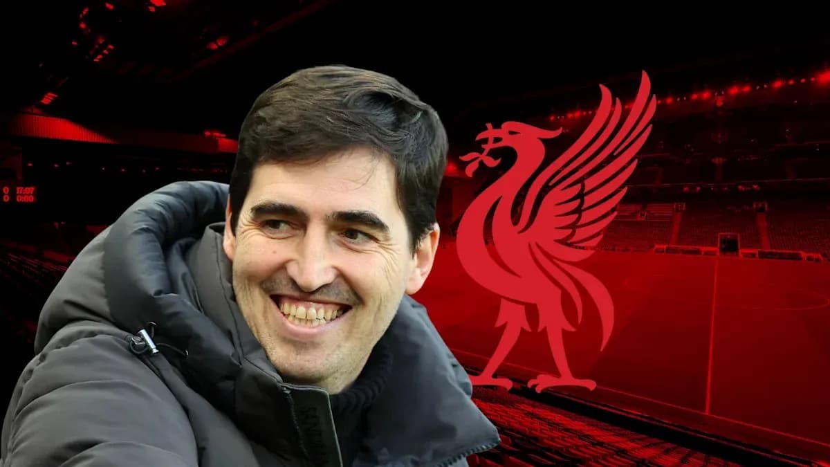 Man smiling with Liverpool logo in background