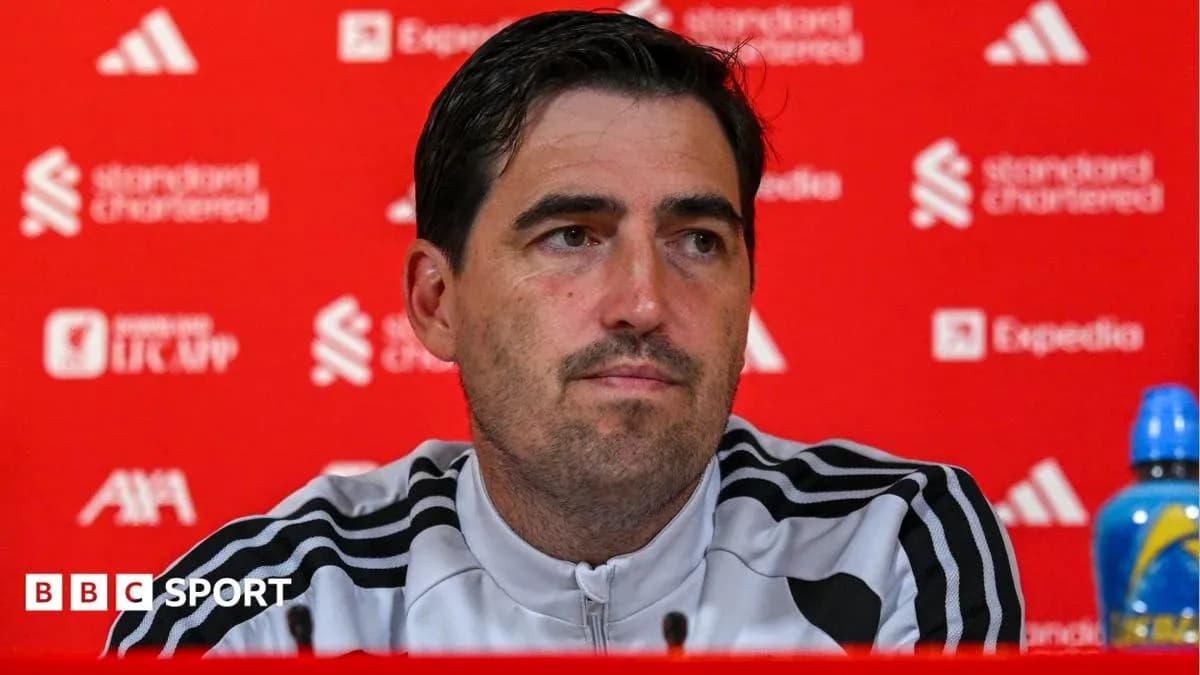 Manager at press conference with branded backdrop
