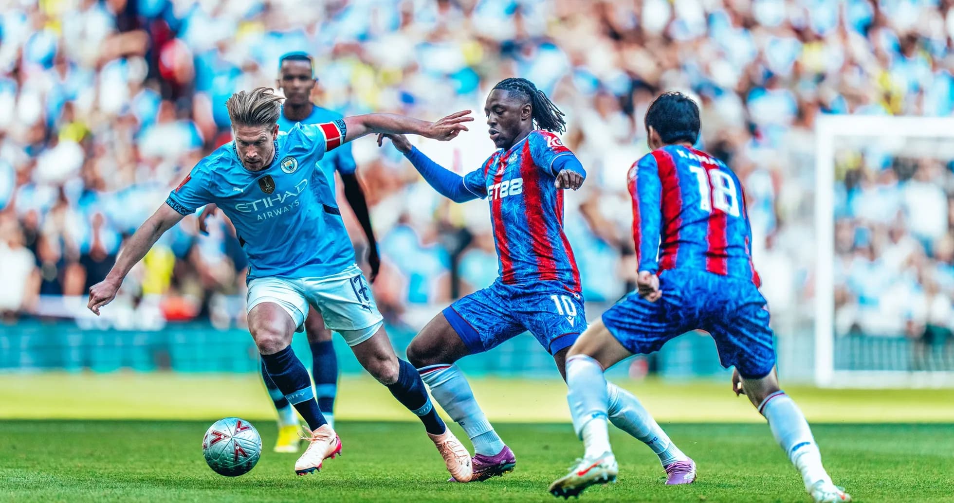 Manchester City player challenged by Crystal Palace defenders
