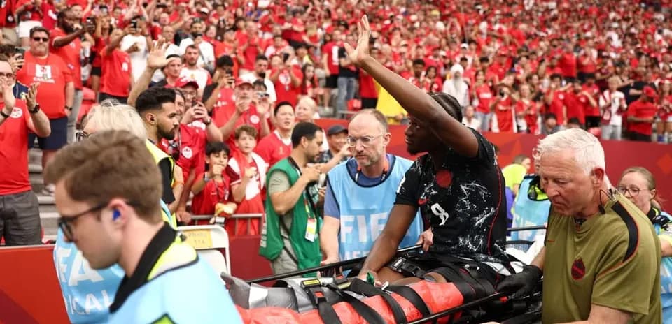 Player being carried off on stretcher by medical staff