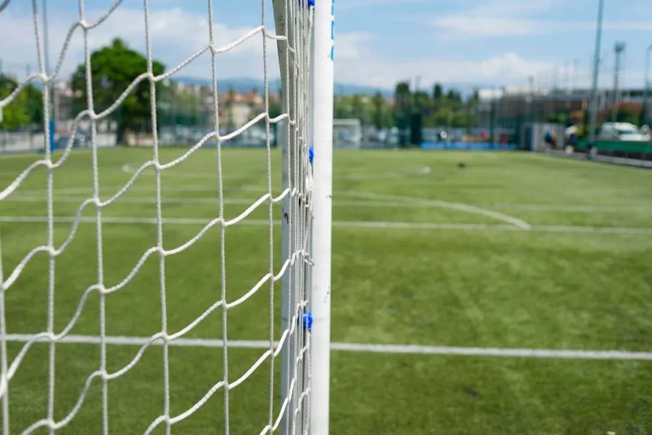 Close-up of goalpost and net on soccer field