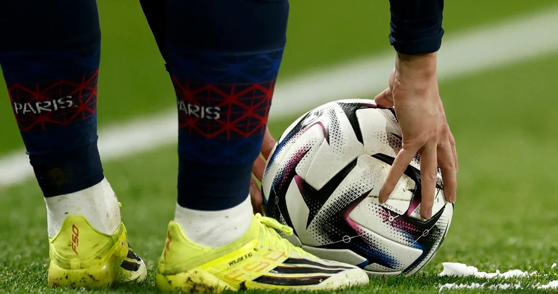 Player placing ball on pitch during match
